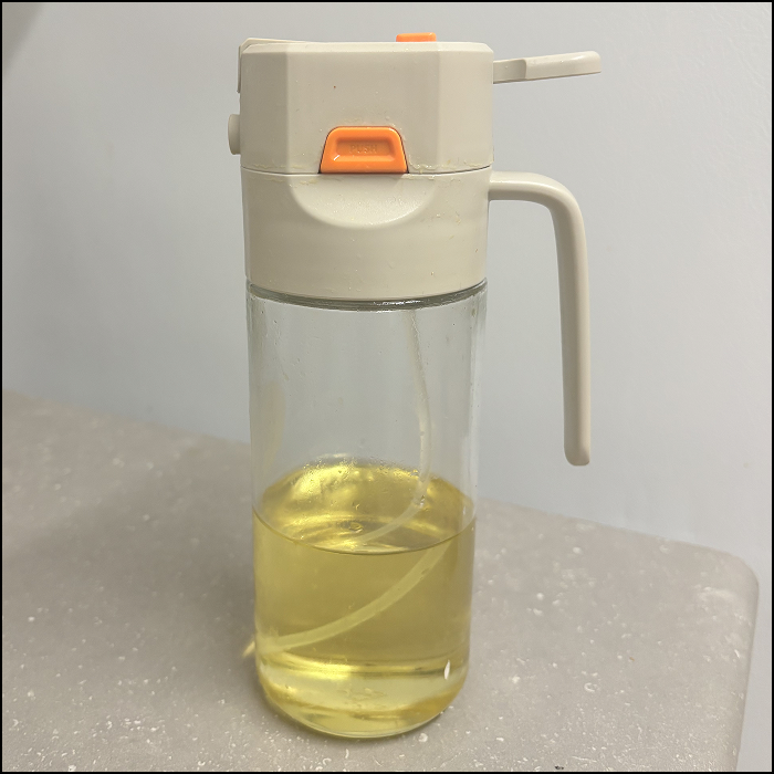 The sound of using the bottle of cooking oil spray.