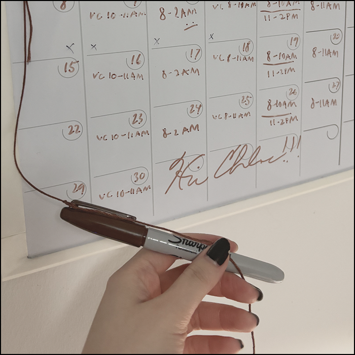 The sound of using a marker to write on the whiteboard.