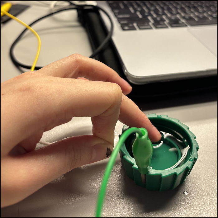 Since water is known to be conductive as well, I attached a clip that touches the surface of the water in a bottle cap.